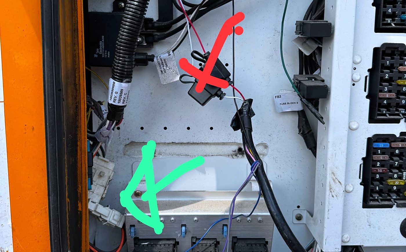Same panel marked up: loose fuse holder crossed out, proper mounting spot marked