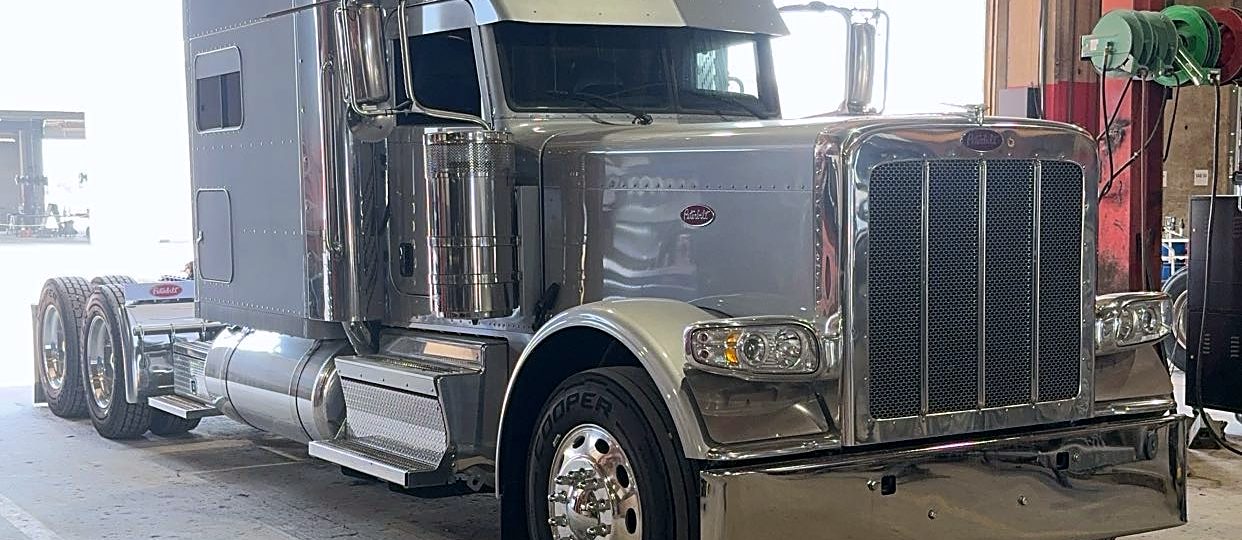 Chrome Peterbilt sleeper tractor parked in the shop