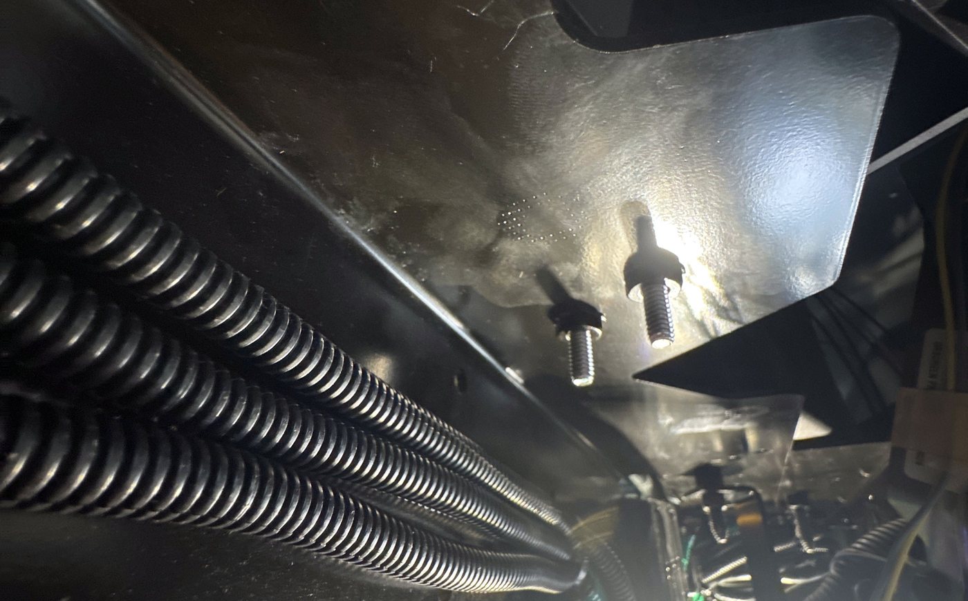 Loomed harness runs secured under a bus seat