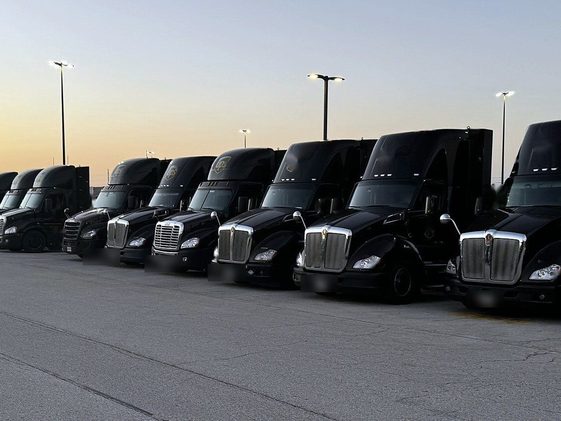Row of highway tractors at sunset