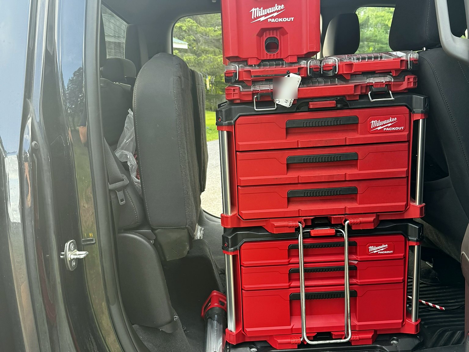 Milwaukee PACKOUT tool stack mounted in the rear cab of a pickup