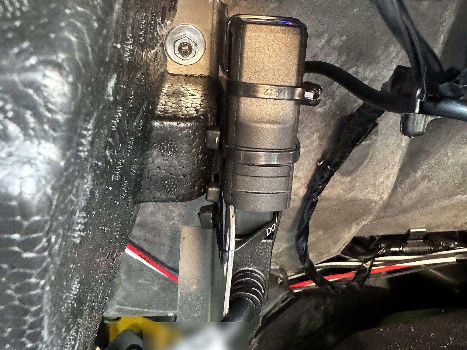 Geotab GO device zip-tied to a bracket under the dash